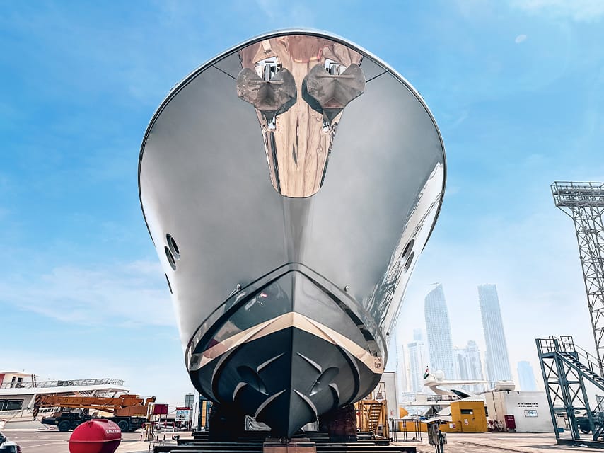 Precision antifouling on the hull of a superyacht is arranged by Edmiston—making yacht repair near me efficient through expert project management.