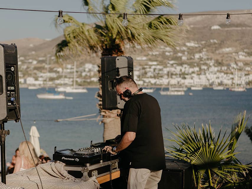 A DJ spins global music at Cabana Bar, Paros, an ideal stop on your mega yacht charter in Greece.