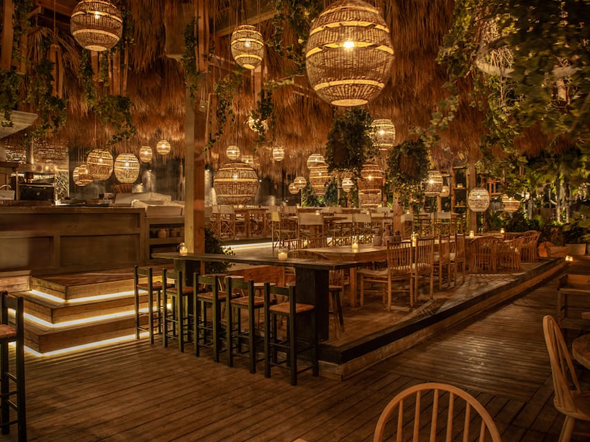 With vines and rattan lighting hanging from the ceiling, Ronda Beach Bar Rhodes is has the ambiance of the best beach bars, to visit on a yacht charter in Greece.