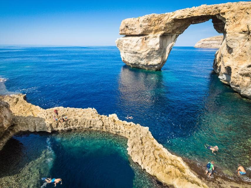 Yacht charter guests enjoy Gozo diving in crystal-clear waters near the submerged Azure Window.