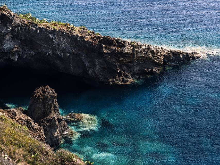 Sheer cliffs meet turquoise seas as guests enjoy a scuba diving Menorca experience on a private Balearic yacht charter.
