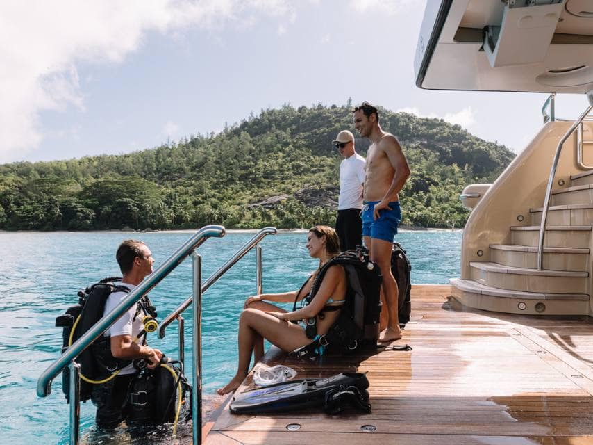 Divers prepare to explore the pristine Cabrera Reserve, a highlight of any Balearic yacht charter.