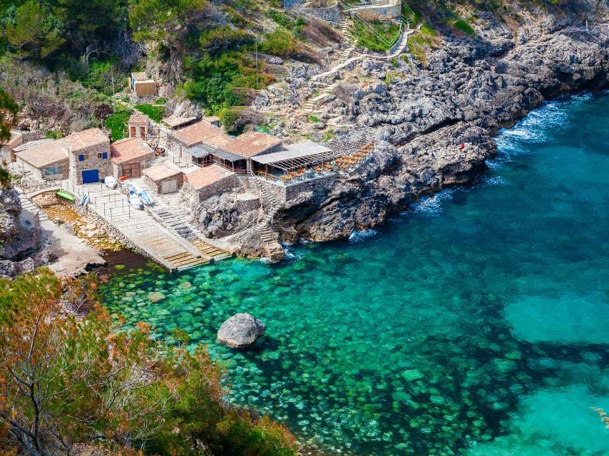 Aerial view of Cala Deia beach — a must-visit stop for stunning coastal views during your mega yacht charter Mallorca.