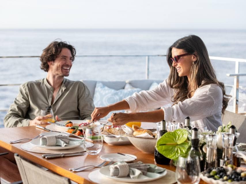 Balcony breakfast for two, part of an intimate and unforgettable luxury yacht honeymoon experience.