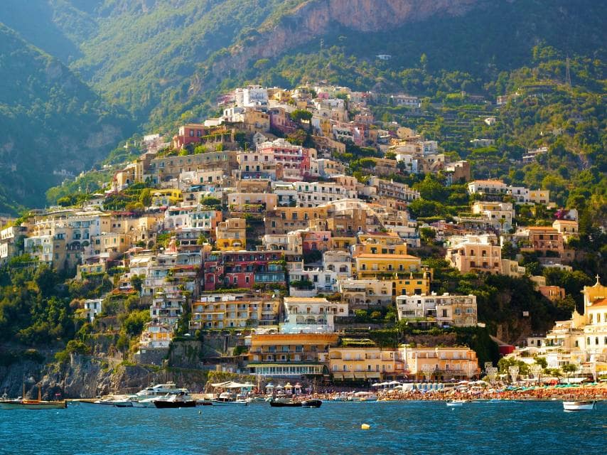 Colorful Positano coastline views from a Mediterranean Sea yacht charter stop in Italy.