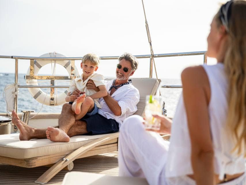 Family enjoying quality time on PERSEUS yacht sundeck during a scenic super yacht holiday.