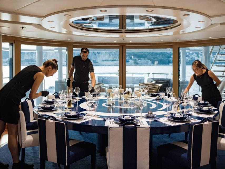 Crew prepares a dinner celebration after yacht registry services are finalised for a new superyacht owner