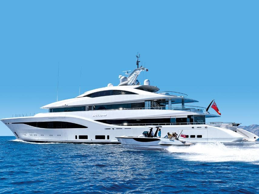 A tender approaches the superyacht ARROW, with a yacht ensign flag visible at the stern.