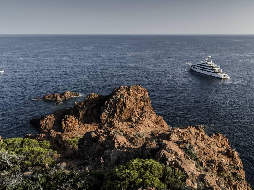 A luxury yacht charters through Menorca’s tranquil waters, discovering one of the most peaceful, quiet Mediterranean destinations.