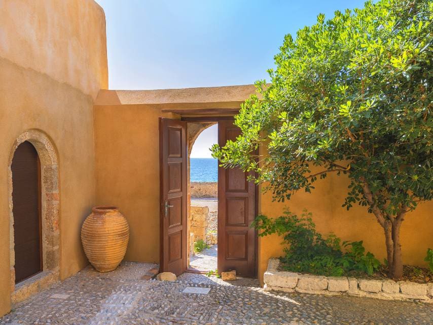 Step back in time at a peaceful Monemvasia house entrance — ideal for Mediterranean charters.