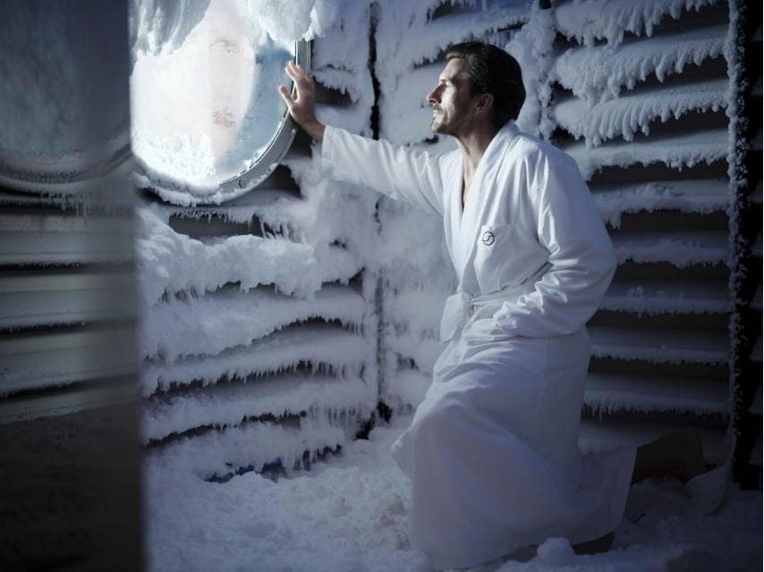 Guest in the snow room sauna, experiencing the unique wellness treatments on a luxury yacht retreat.