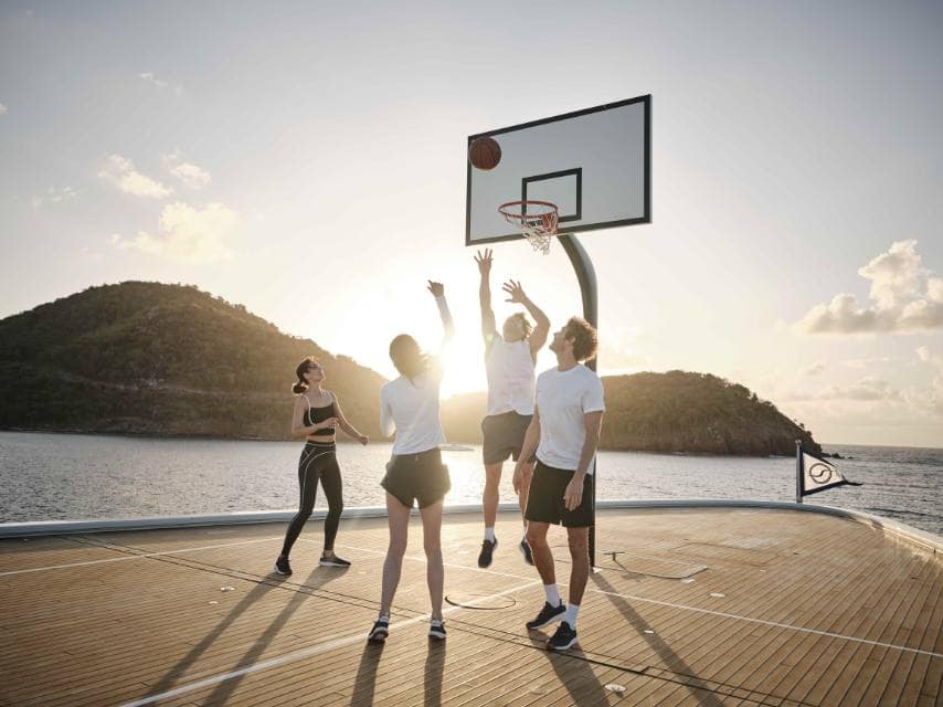 Superyacht basketball court hosts a friendly game, keeping guests active and engaged during their wellness charter.