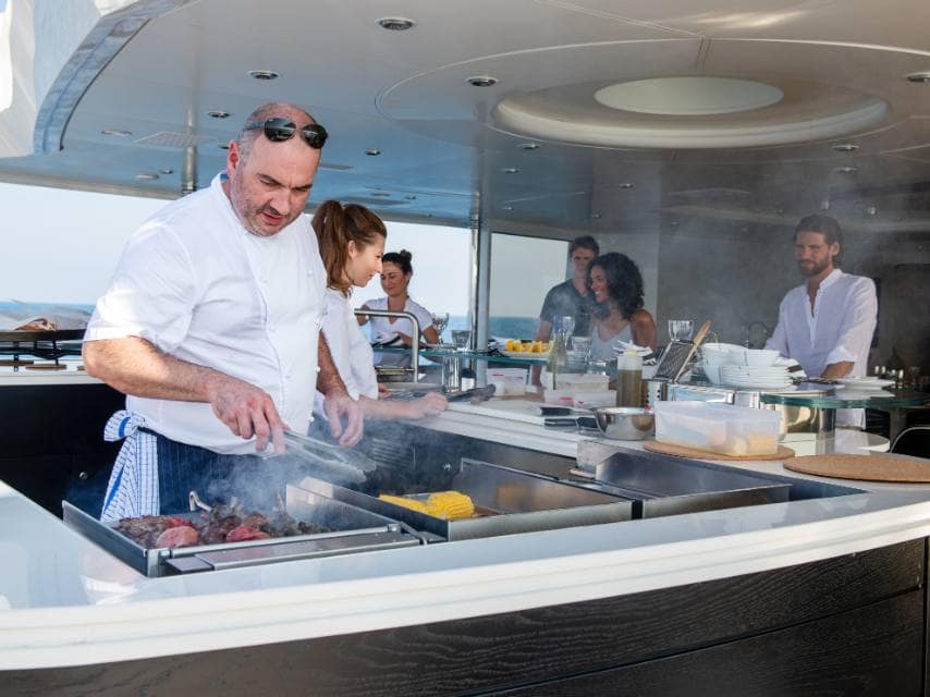 Guests indulge in fresh, healthy gourmet dishes prepared by a private chef during their luxury wellness charter.