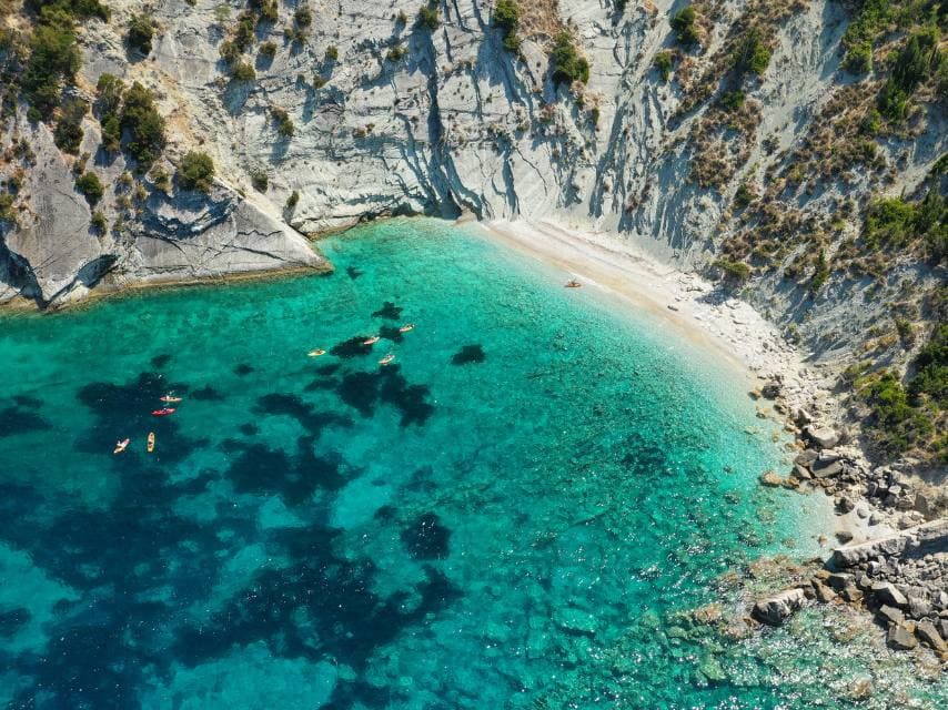 Charter guests kayak at Afales Beach, after exploring one of the best Greek mythology sites in Ithaca.