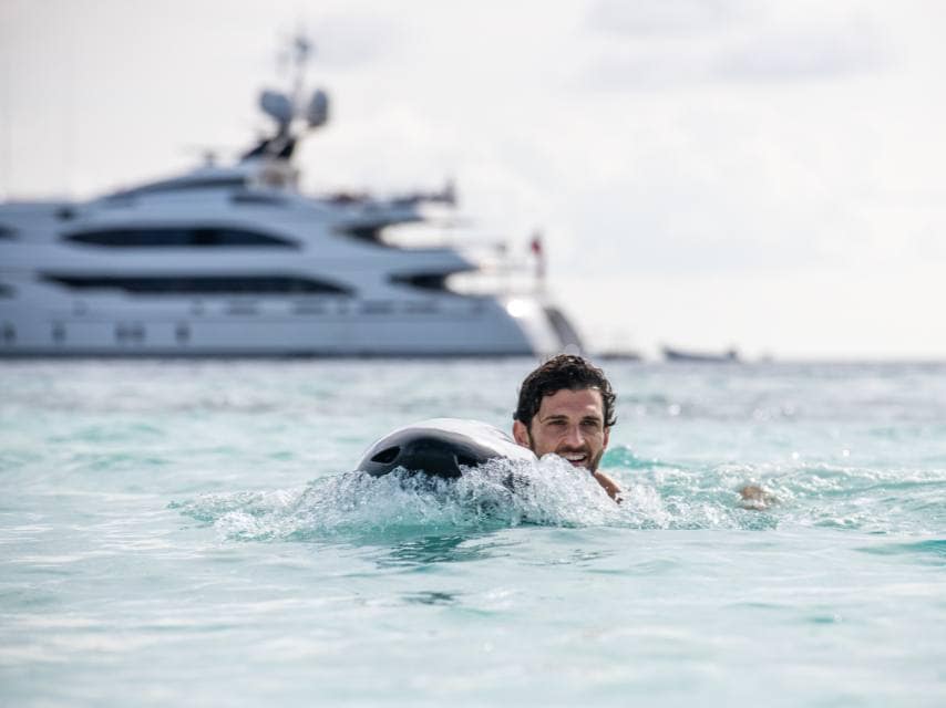 Guest swims from JAGUAR yacht in Polis Bay, soaking in the wonders of Ithaca Greek mythology.