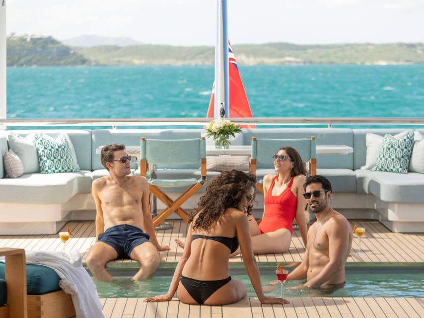Friends enjoying yacht pool vistas over the Ionian Islands — the best of a luxury yacht charter Europe experience.