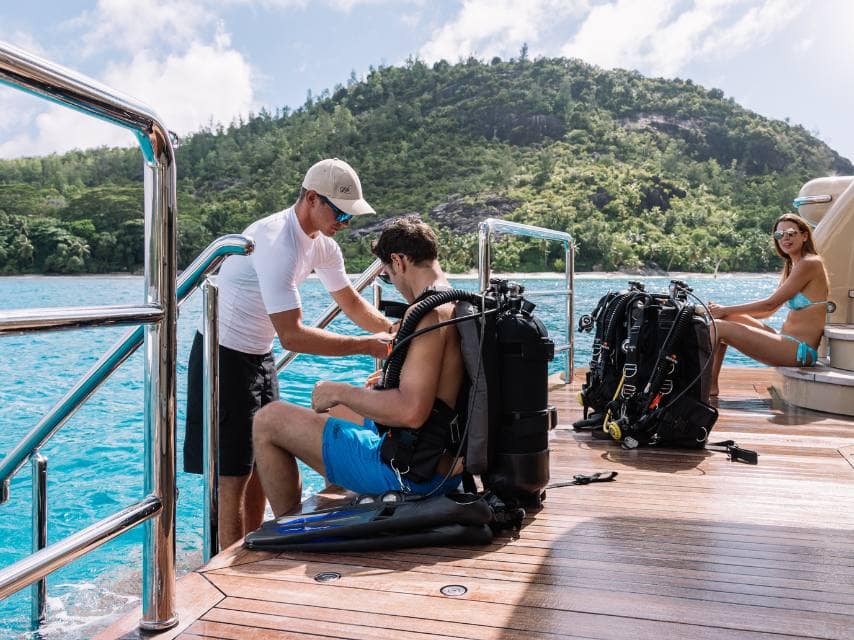 Guests preparing to scuba dive aboard a caribbean superyacht charter.