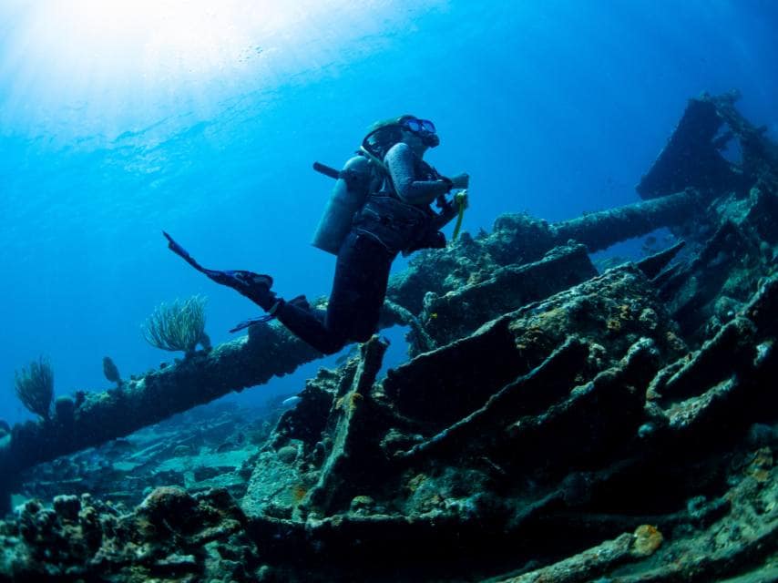 Luxury guests enjoy wreck diving during a yacht charter at several remote caribbean dive destinations.