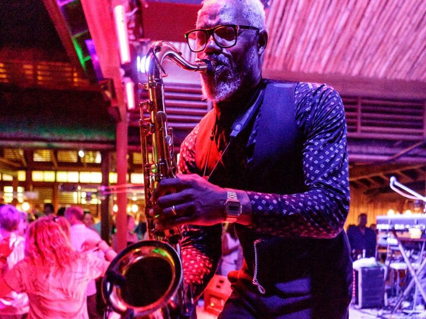 Live sax at Mustique Blues Festival during an intimate seaside stop on a Grenadines yacht charter.