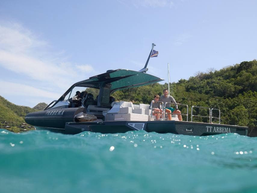 Father and son setting off to explore hidden bays during their caribbean mega yacht charter.