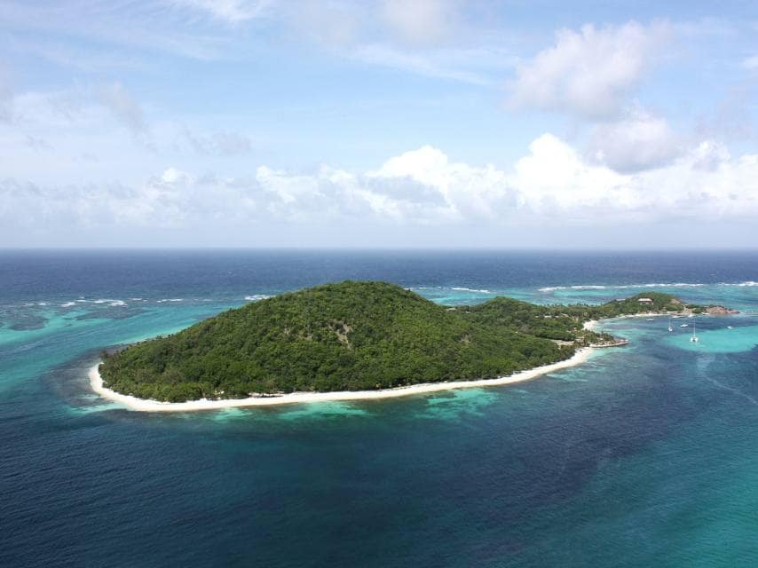 Petit St Vincent offers white sands and calm seas for a private yacht charter exploring remote Caribbean islands.