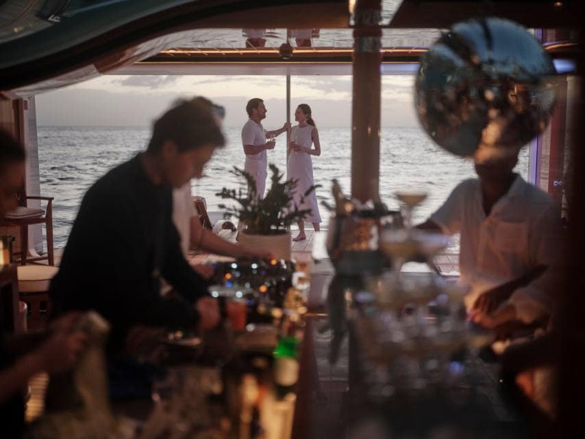 Couple enjoying a sunset toast aboard a private yacht after the St Lucia jazz and arts festival.