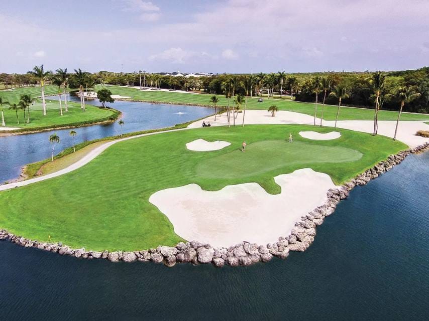 Guest enjoying a Miami golf break at Ocean Reef Golf Club, complementing their curated Miami charter yachts Art Basel schedule.