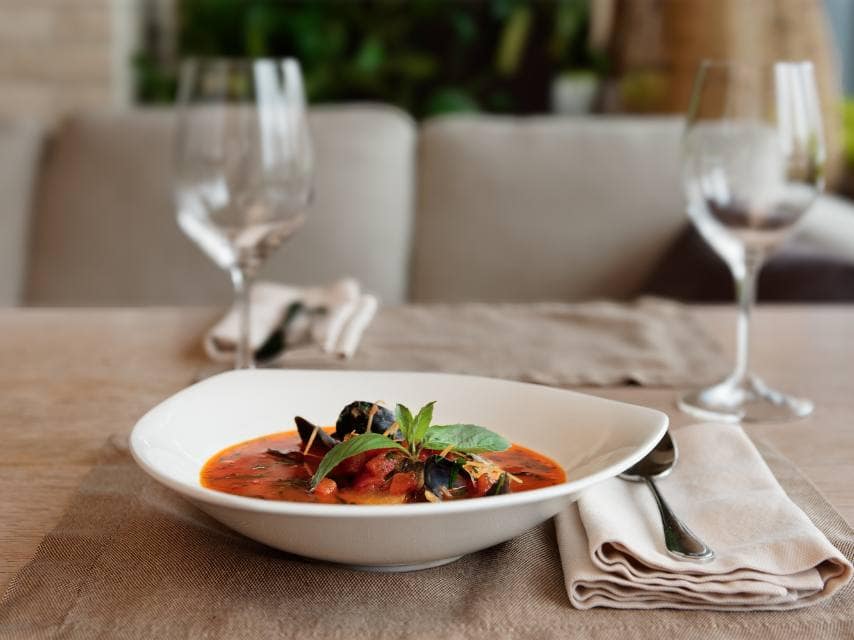 Martinique yacht charter guests enjoy French-Caribbean cuisine alfresco on deck.