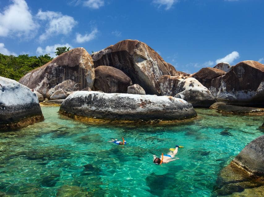 Kids snorkelling around the rock boulders at the Virgin Gorda, The baths
