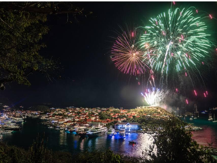 Viewed from a Christmas yacht charter, New Year's fireworks display over St Barths’ Gustavia Harbour.