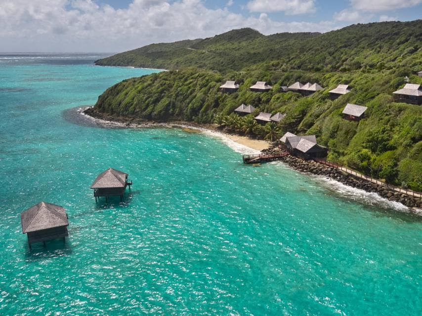 Caribbean superyacht charter guests enjoy hillside palazzo views at Mandarin Oriental, Canouan, one of the best luxury Caribbean spas.