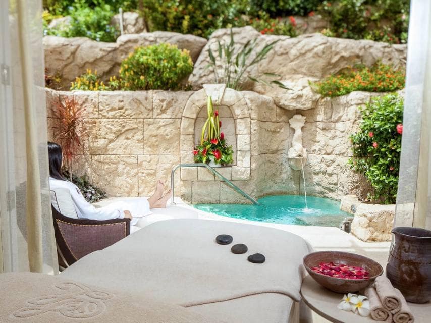 A woman unwinds in a private pool at Sandy Lane Spa, one of the best luxury spas in Caribbean.