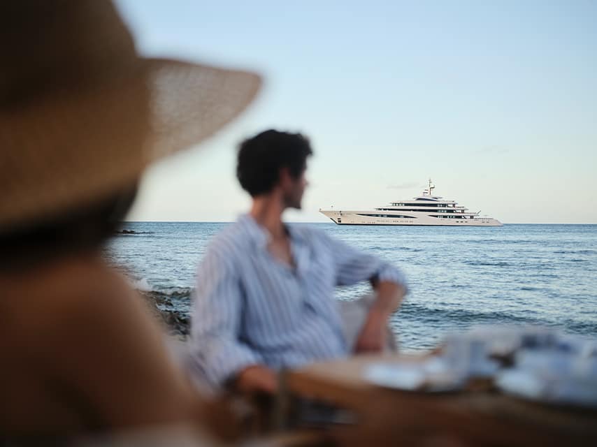 Sophia yacht anchored off a beach