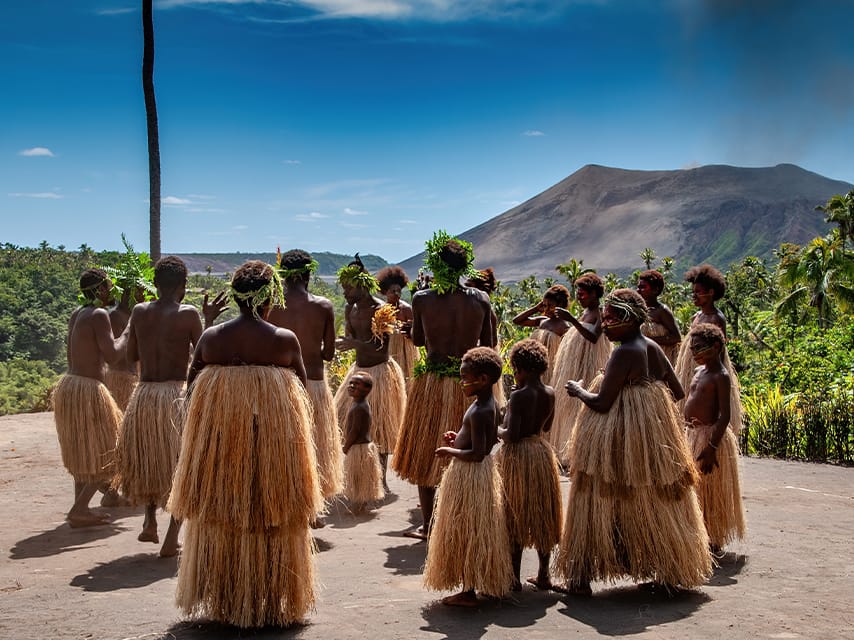 Tanna Island, Vanuatu - September 24, 2015: Traditional Melanesian dance performance by villagers on remote Tanna Island, with active volcano Mt Yasur in the background.