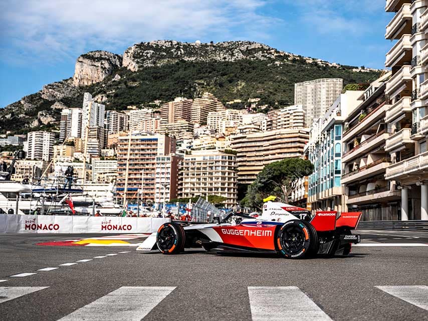 Monaco grand prix from a yacht offers views of Formula 1 cars racing past the Monte Carlo harbour and skyline.