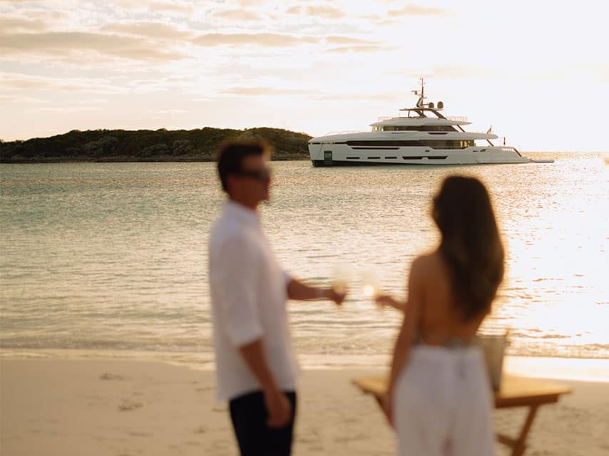 PERLA BIANCA couple looking into the sunset at their luxury superyacht