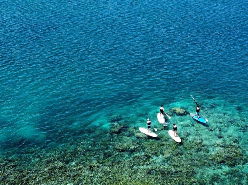 Paddle boarding in Fiji with crystal clear waters