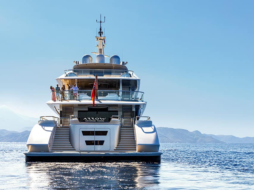 Luxury yacht charter Greek islands guests relax aboard the 75.0m Feadship superyacht ARROW as she cruises calm waters.