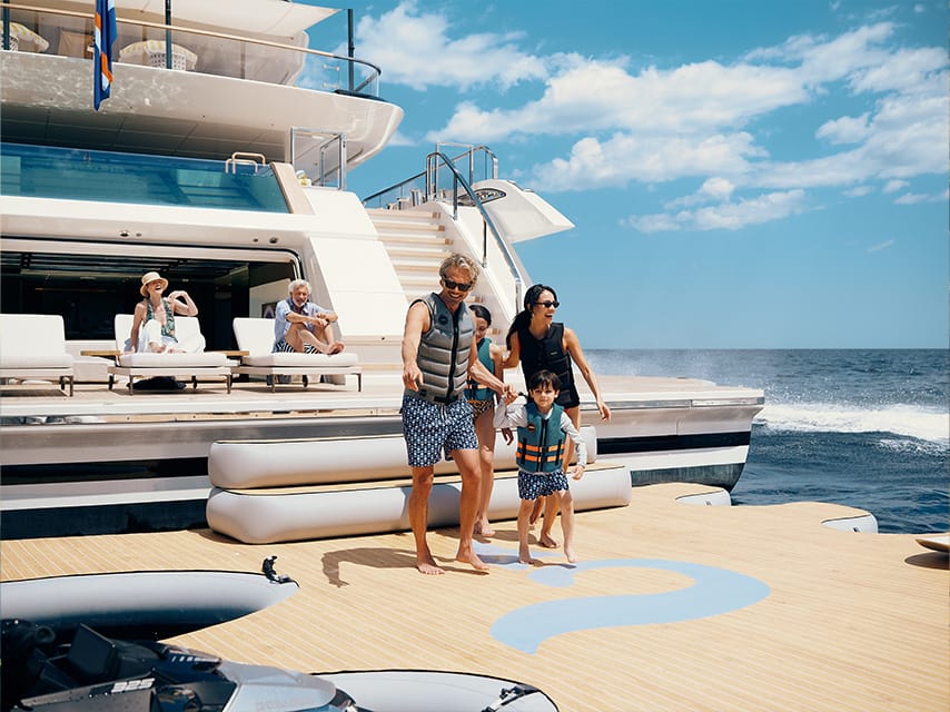 A superyacht charter in Greece welcomes a family onto the swim platform of the 72m Sanlorenzo SILVER FOX.