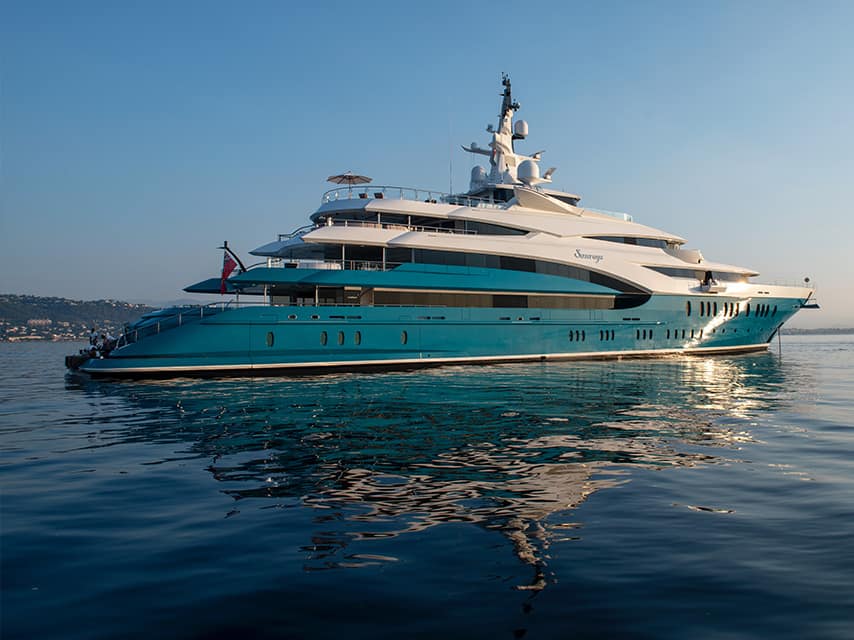 A Greek islands yacht charter offers views of the teal-hulled 86m Oceanco superyacht SUNRAYS at anchor.