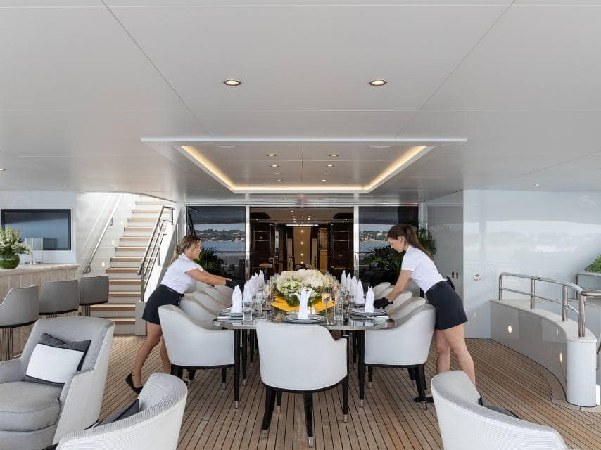 Yacht crew setting up dinner table