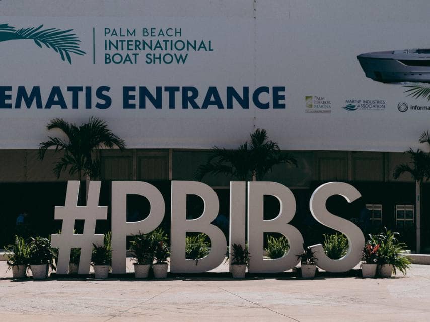 The Palm Beach Boat Show 2026 landmarks include the vibrant #PBIBS sign along the scenic Flagler Drive waterfront.