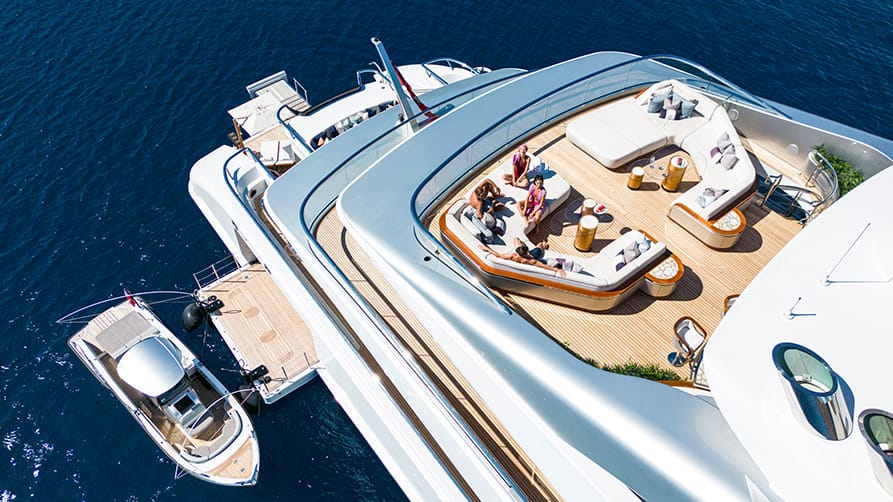 Top view of a superyacht refit with people lounging, highlighting the luxury yacht lifestyle