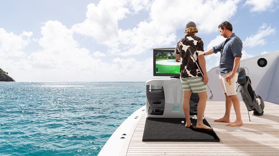 Two friends enjoying a game of golf with their new luxury yacht accessories