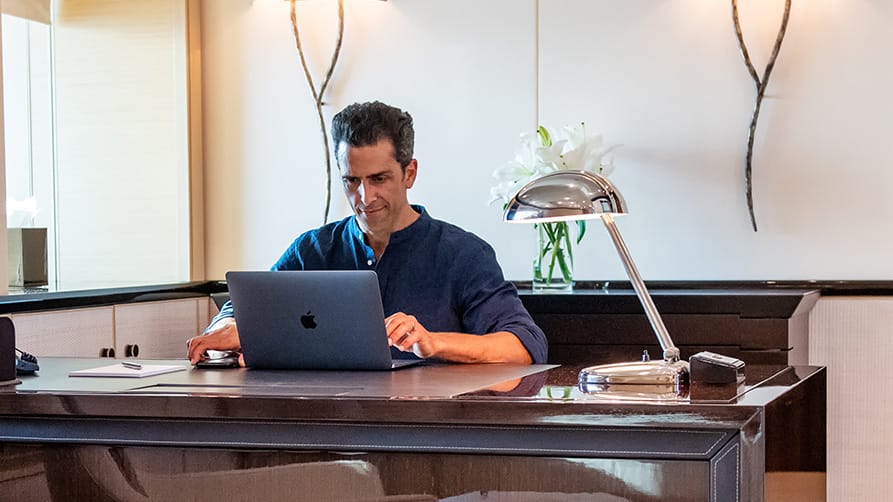 A member of Edmiston's yacht refit management team creating a project on a computer