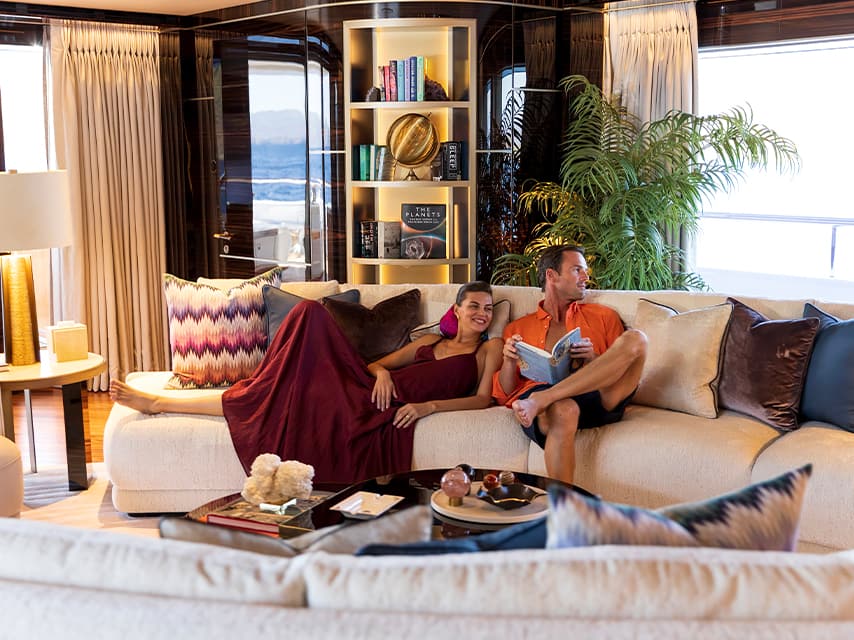 Couple relaxing in their luxury superyacht charter salon