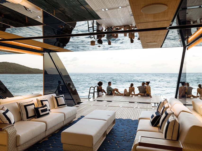 Group of friends sitting on the deck of their Cannes Film Festival yacht charter