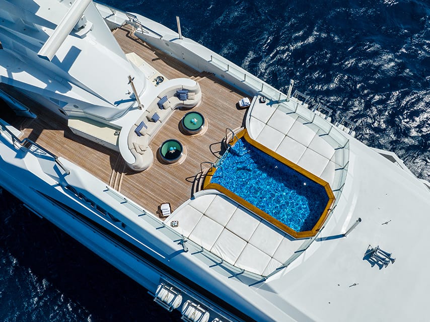 Aerial view of a luxury pool deck featured in the Edmiston superyacht buying guide.