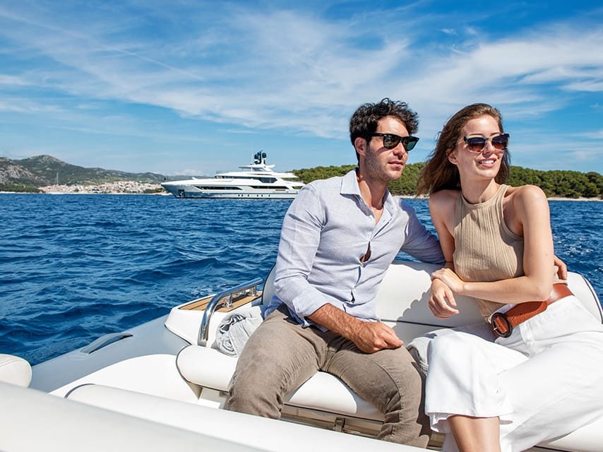 A couple enjoys exclusive viewing spots as part of their Paris 2024 yacht charter package.