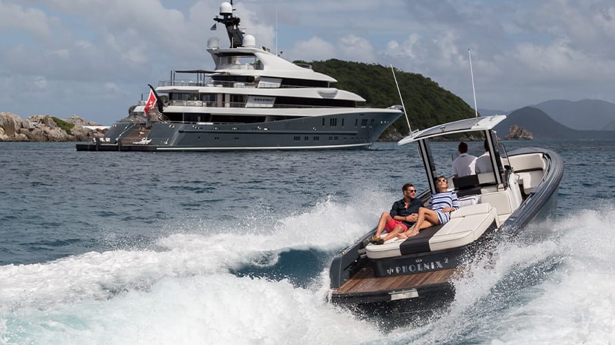 A couple on a boat, with their yacht accessories, getting ready to board a superyacht